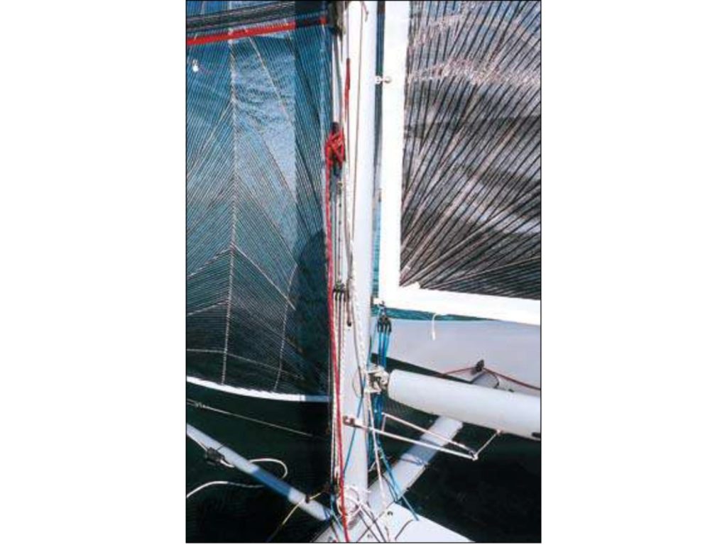 The jib halyard cleats on a cleat mounted on a sliding track.