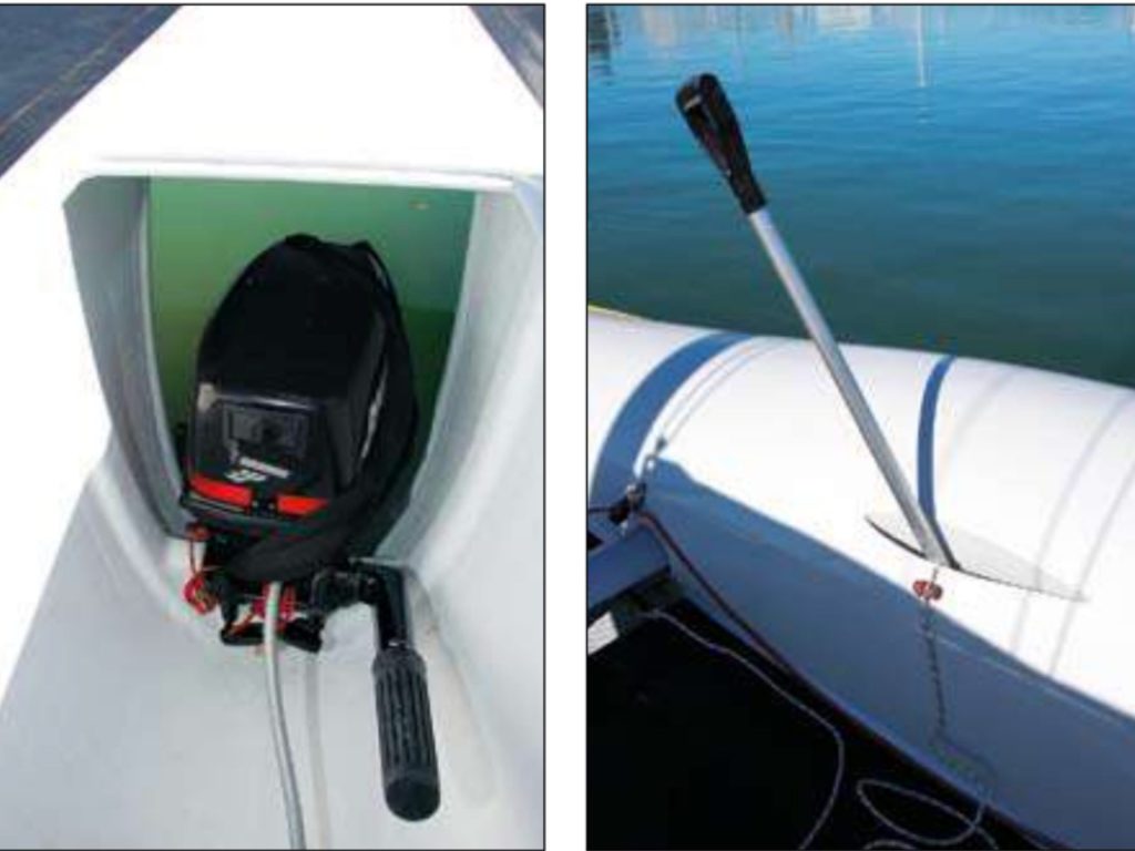 A central pod supports the outboard motor and stiffens the main beam. Spade handles raise and lower the daggerboards.