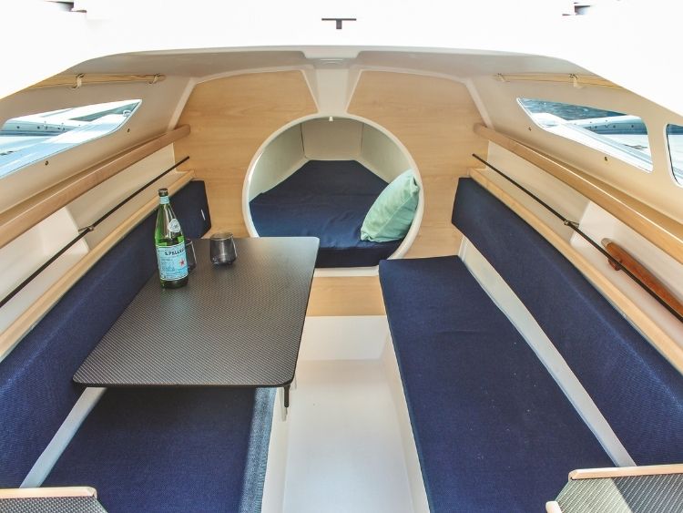 Inside the Dragonfly 25 Sport, where bench seating, a folding table and forward berth give the 7.65m trailer-sailer three-berth accommodation. // Photo credit: Kevin Green