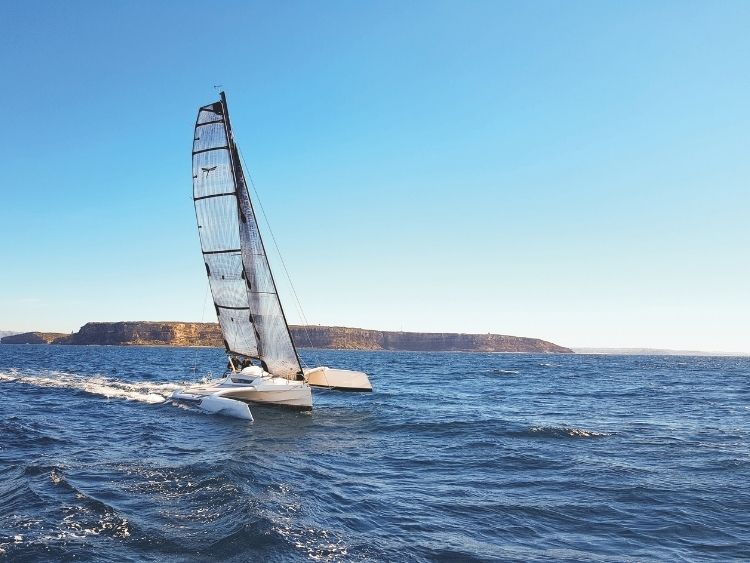 The Dragonfly 25 Sport making pace offshore, its 5.8m sailing beam and long amas providing the wide stance that defines the folding trimaran. // Photo credit: Kevin Green