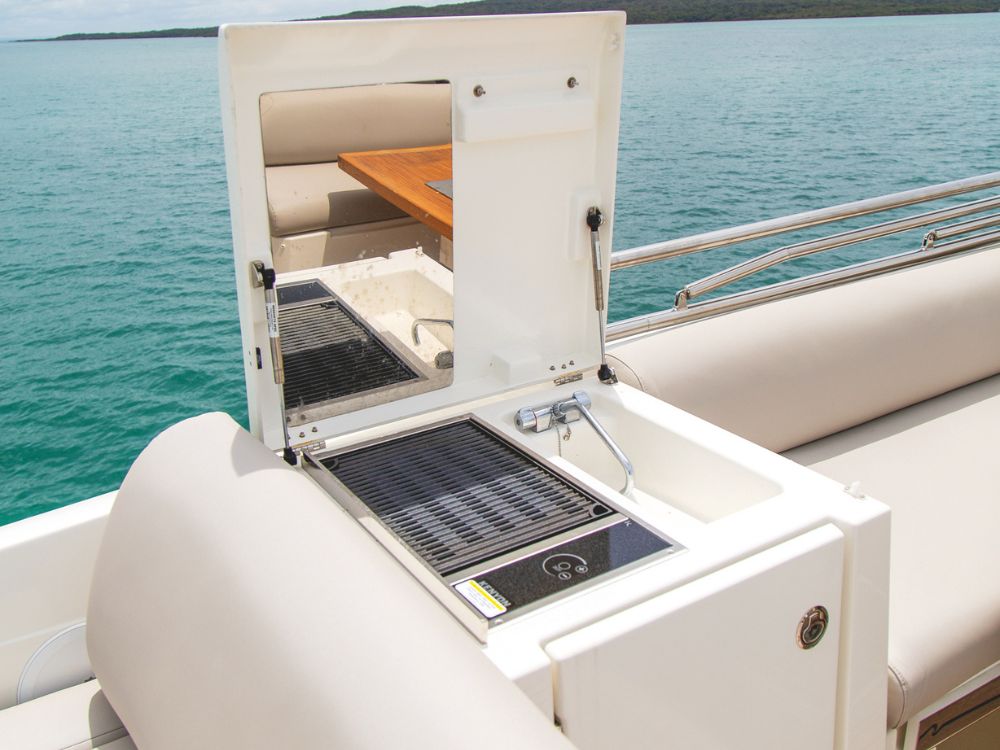 A Prestige 630S wet bar and grill on the flybridge are ready for outdoor entertaining.