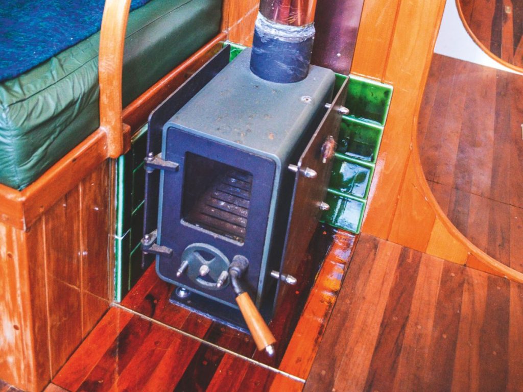 Plenty of recycled timber features in the boat’s interior; a decent-sized nav station; the heat from the wood burner enhances the cosy ambience