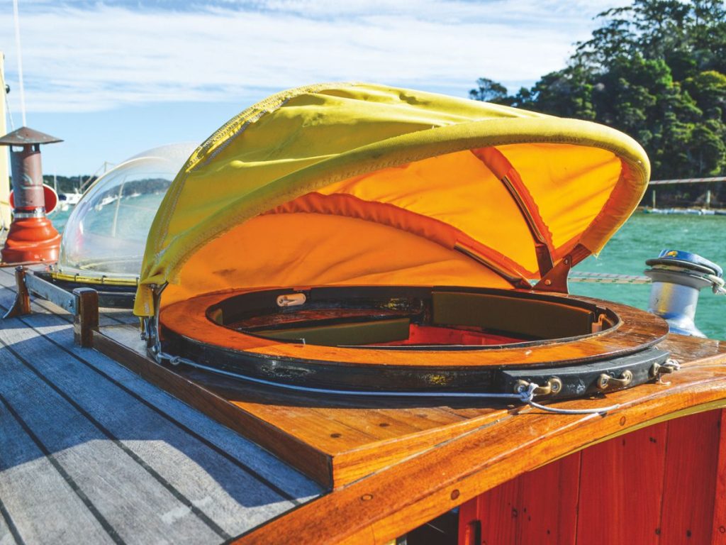The 6hp Tohatsu, and the junk rig’s simple reefing lines; a dome helps to keep Annie dry when the weather’s foul.