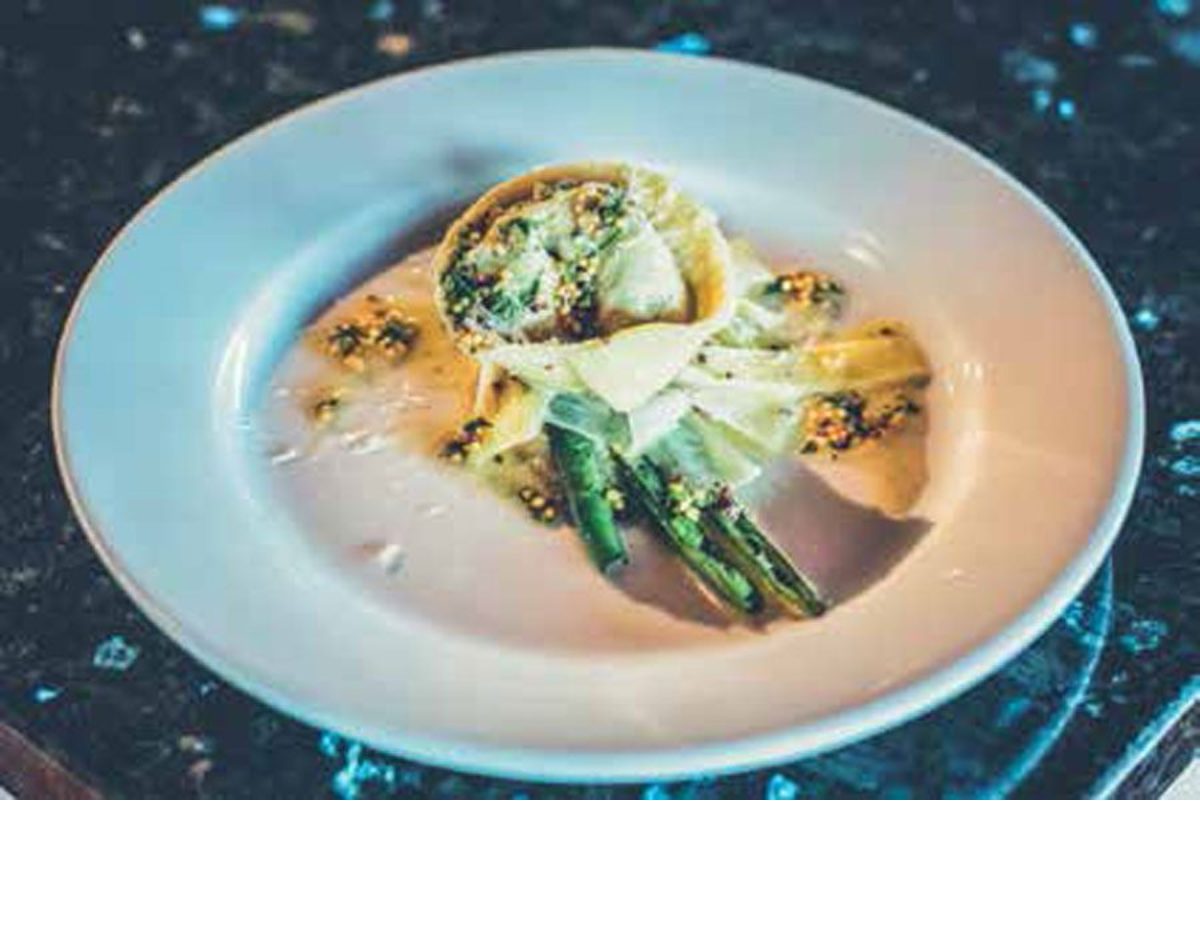 Grant prepares gourmet meals, embellishing the dining experience with information about the products and method of preparation.