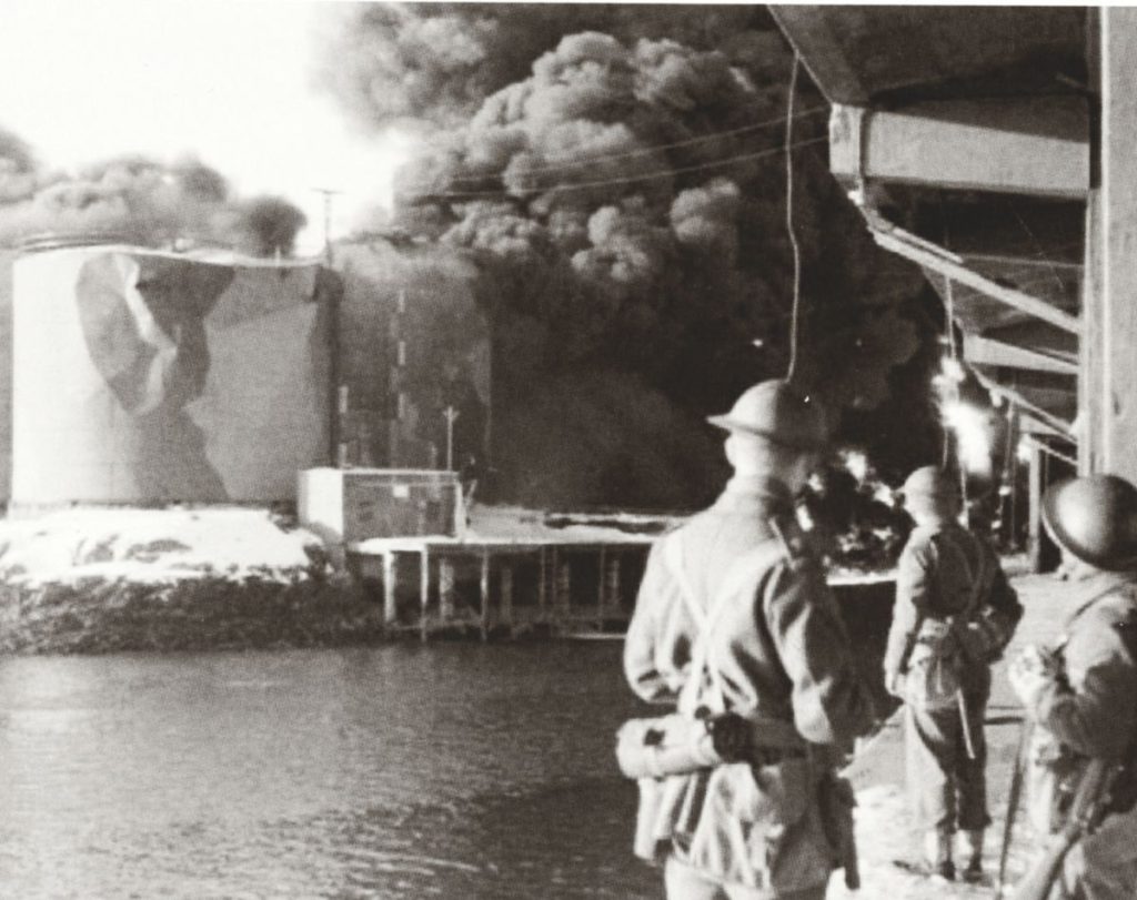 The oil tanks blazing on the Lofoten Islands, February 1941. One man and his boats: Harold George; Victory at war