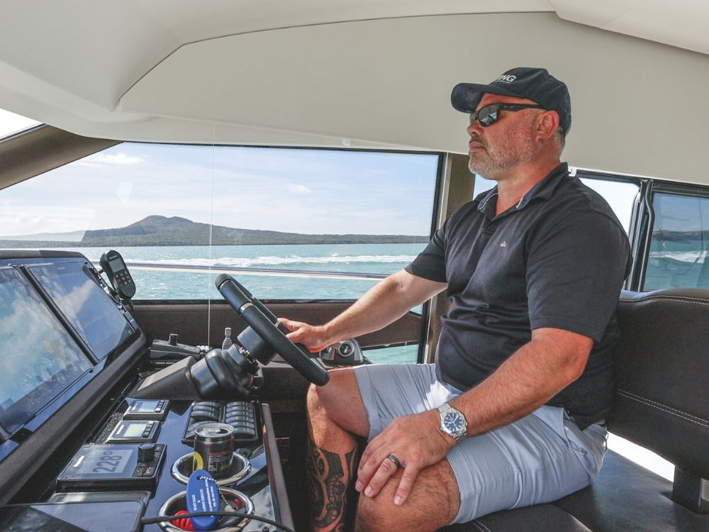 The helm console is well laid out with everything within reach and easy to see. The flybridge version we tested had the larger IPS 650 engine package and both models have remote anchoring. // Photo credit: Roger Mills
