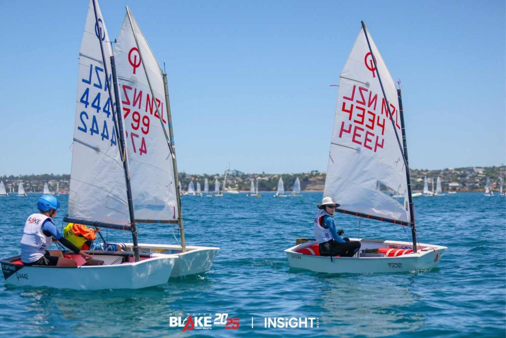 (R-L) John Paterson, Carter Smith, and Alexander Clark racing in the Optimist White class. // Photo credit: Insight Media