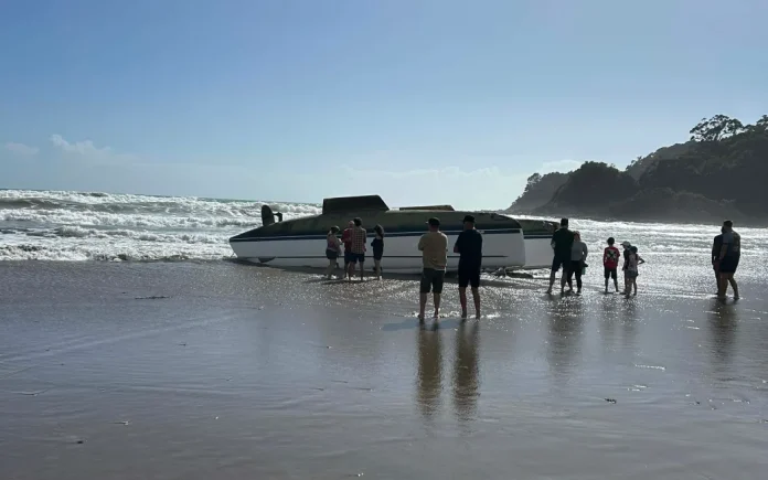 Rescuers came to the add of a capsized yacht on Sandy Bay Beach in Northland. Photo- Supplied