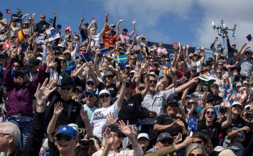 Spectators cheer from the grandstand ahead of the action on Race Day 2 of the ITM New Zealand Sail Grand Prix in Auckland, New Zealand. Saturday 14 February 2026. Rolex SailGP Championship Event 2 2026 Season. // Photo credit: Iain McGregor for SailGP.
