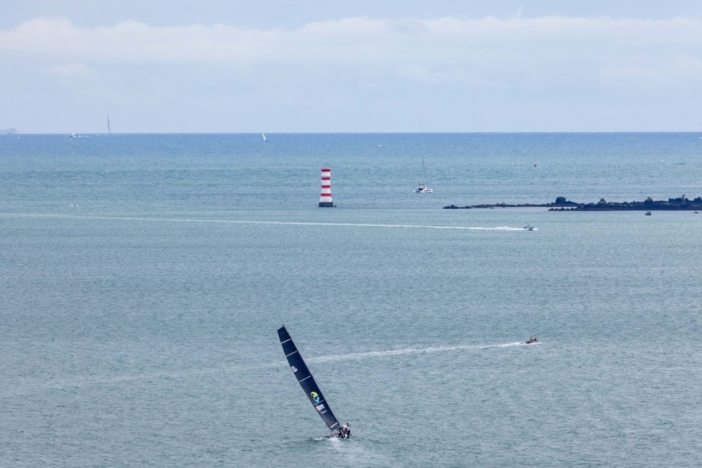 Explore Racing sailing the gap between Rangitoto Island and Northshore, heading towards the outer Gulf Harbour area // Photo credit: Roger Mills / Boating New Zealand