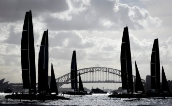 Silhouette of the F50 catamaran sleet racing past the Sydney Harbour Bridge on Race Day 1 of the KPMG Australia Sail Grand Prix in Sydney, Australia. Saturday 28 February 2026. Rolex SailGP Championship Event 3 2026 Season. // Photo credit: Brett Phibbs for SailGP.