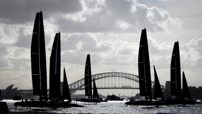 Silhouette of the F50 catamaran sleet racing past the Sydney Harbour Bridge on Race Day 1 of the KPMG Australia Sail Grand Prix in Sydney, Australia. Saturday 28 February 2026. Rolex SailGP Championship Event 3 2026 Season. // Photo credit: Brett Phibbs for SailGP.