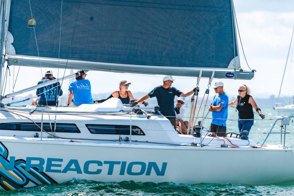 Chain Reaction competing in the 2025 PIC Harbour Classic (A vibrant fleet takes to the Waitematā Harbour as the PIC Harbour Classic returns this weekend) // Photo credit: Live Sail Die