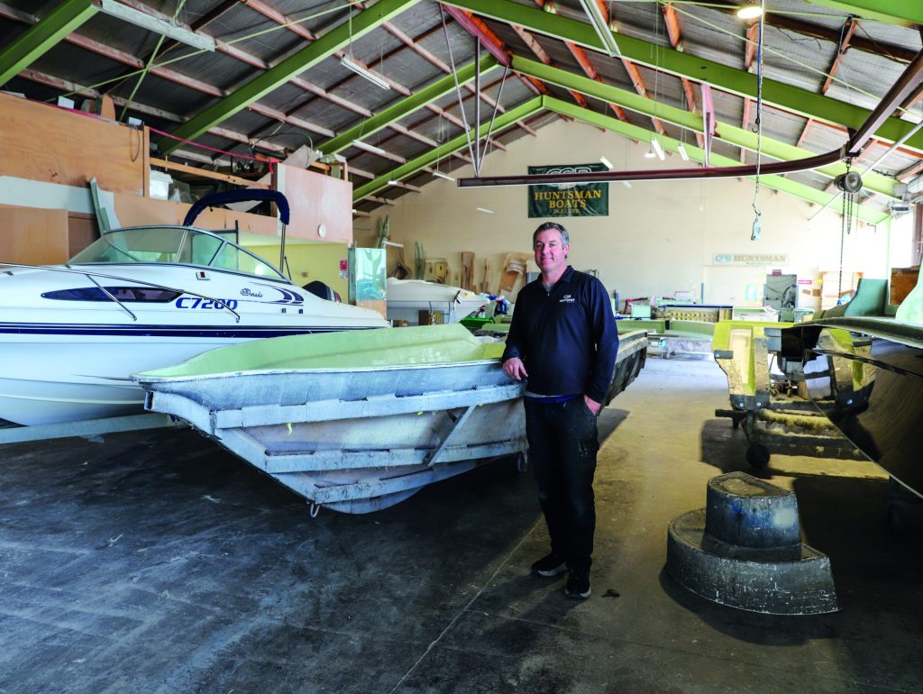 Mike with one of the Huntsman moulds and putting the finishing touches to a new boat.