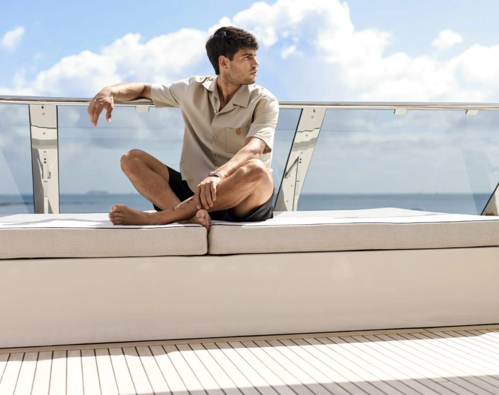 Carlos Alcaraz leaning on the railing of a 80 Sunreef Power yacht // Photo credit: Sunreef