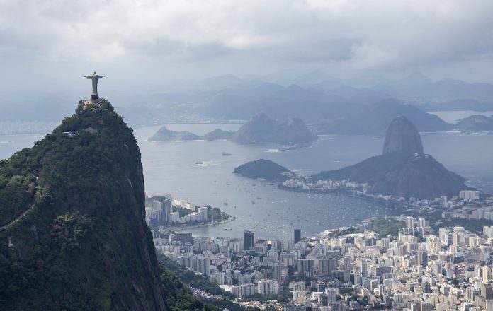 Christ the Redeemer and the Rio de Janeiro skyline, on Race Day 2 of the ENEL Rio Sail Grand Prix in Rio de Janeiro, Brazil. Sunday 12 April 2026. Rolex SailGP Championship Event 4 2026 Season. // Photo credit: Gabriel Heusi for SailGP.