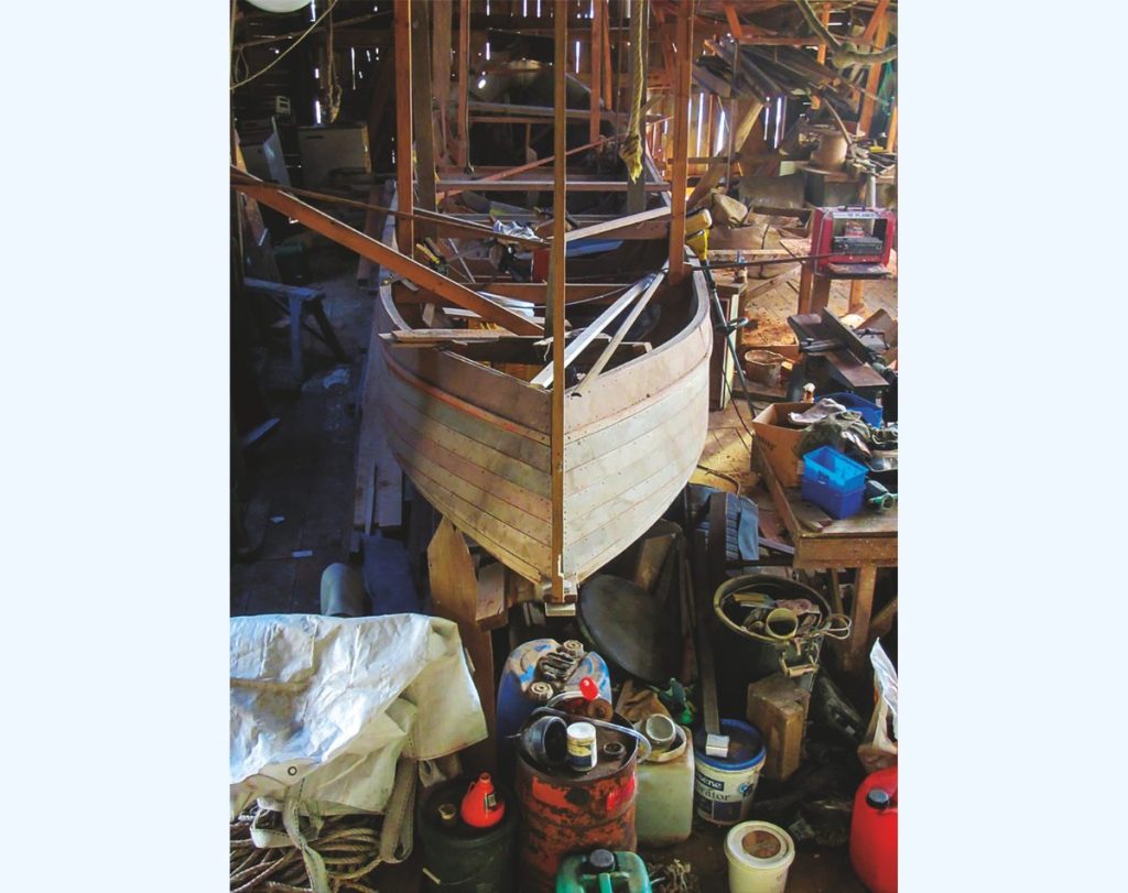 Tanekaha or ‘Splinter’ undergoing restoration in the boatshed. // Photo credit: Lesley Stone