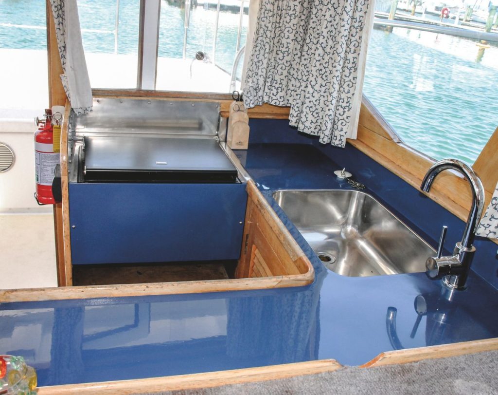 Where possible, he kept the boat’s interior true to the original Careys Boatyard conversion, but the galley now features a Wallas diesel cooktop. // Photo credit: Kevin Cudby / Boating New Zealand 