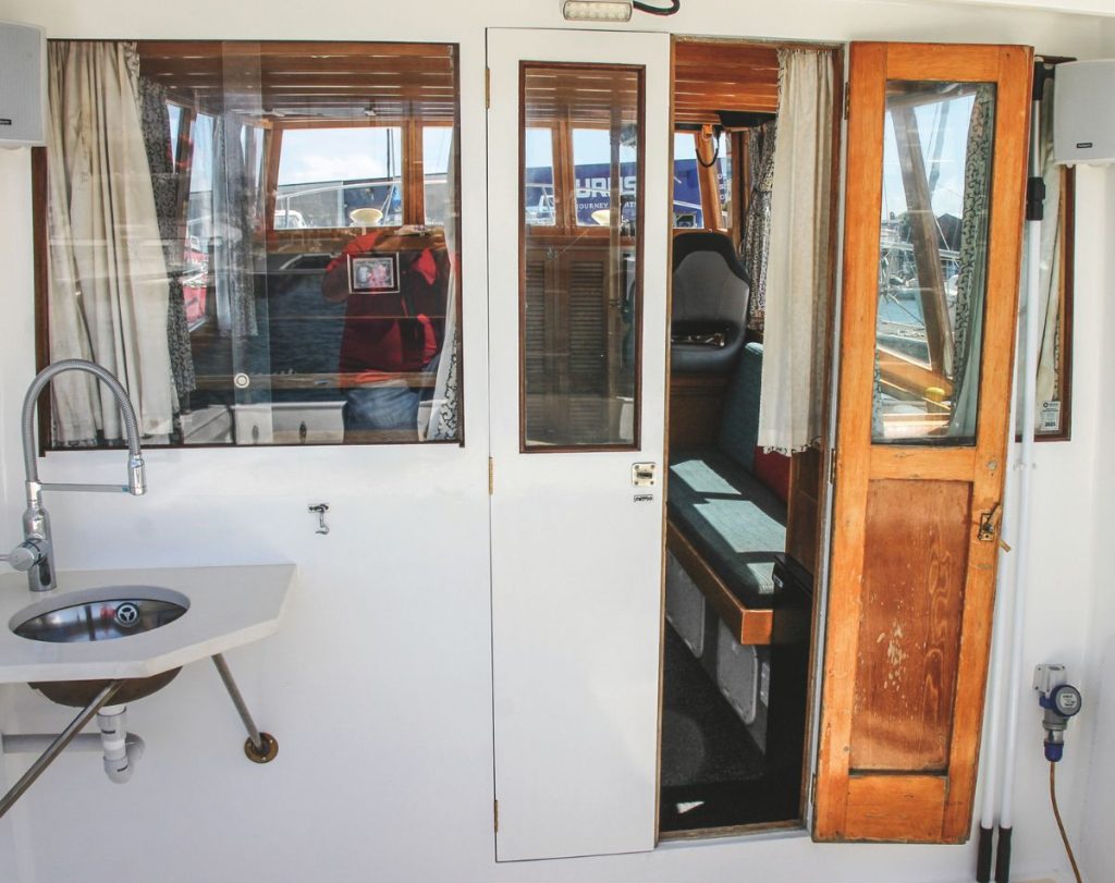 Where possible, he kept the boat’s interior true to the original Careys Boatyard conversion, but the galley now features a Wallas diesel cooktop. // Photo credit: Kevin Cudby / Boating New Zealand 