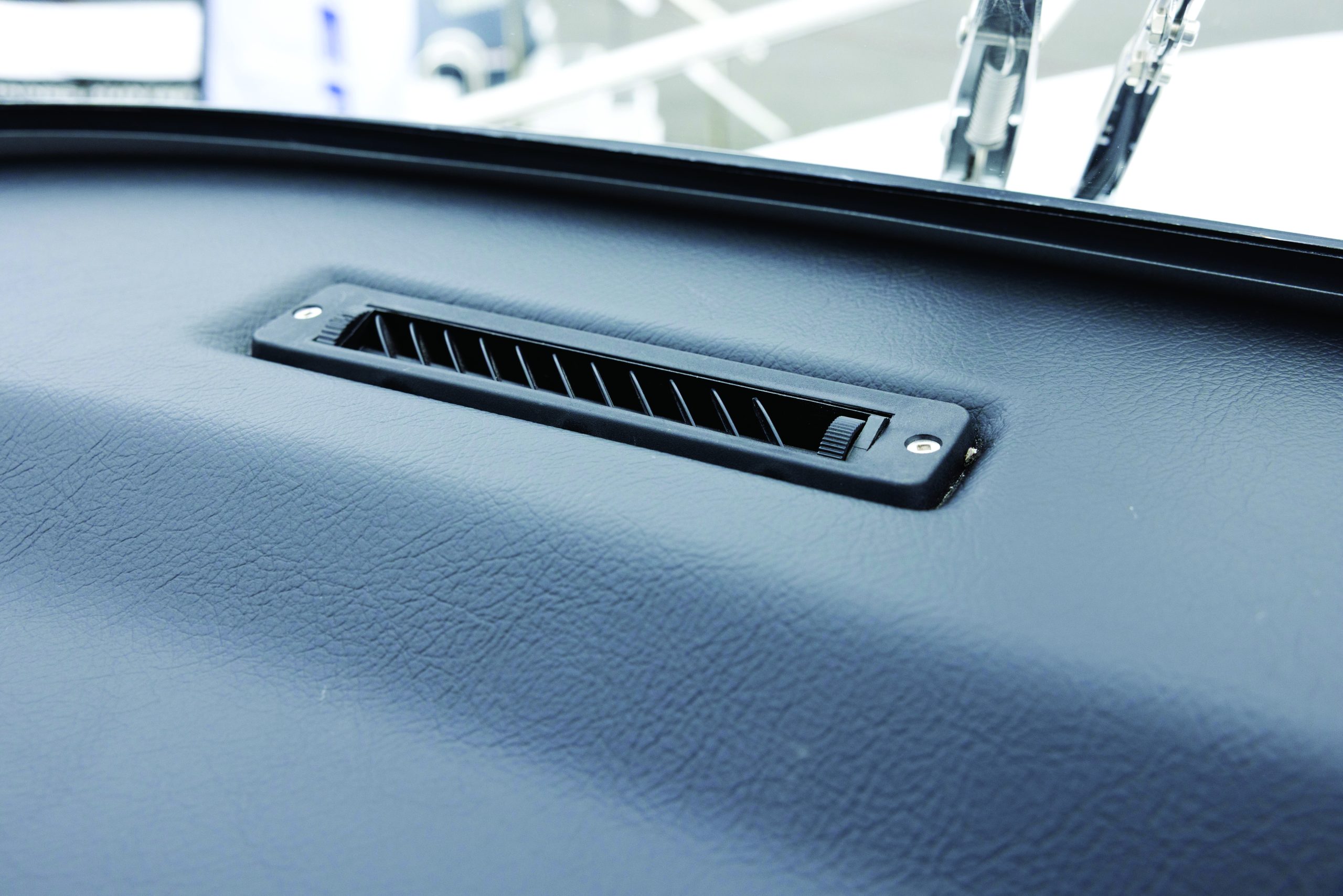 Close-up view of a black air vent installed in the boat's interior surface. // Photo credit: supplied.