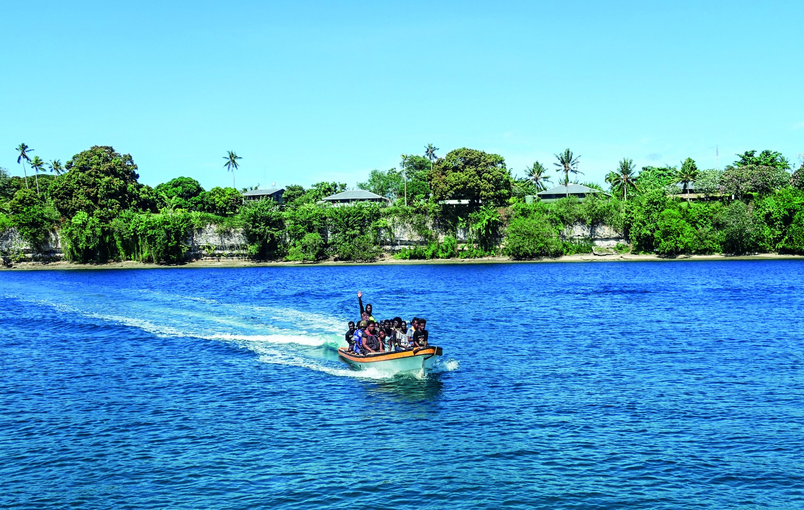 Hailing a well loaded taxi boat in Buka // Photo credit: BIRGIT HAKL.