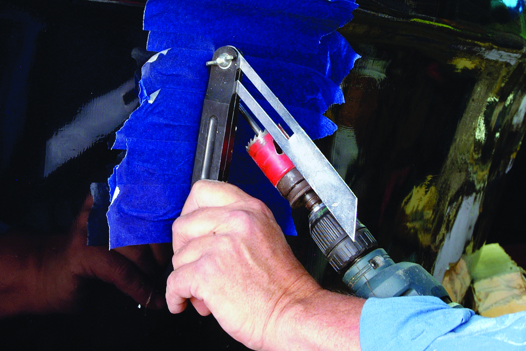 A person's hand operates a fuel nozzle while refueling a boat at a marine fuel dock // Photo credit: supplied.