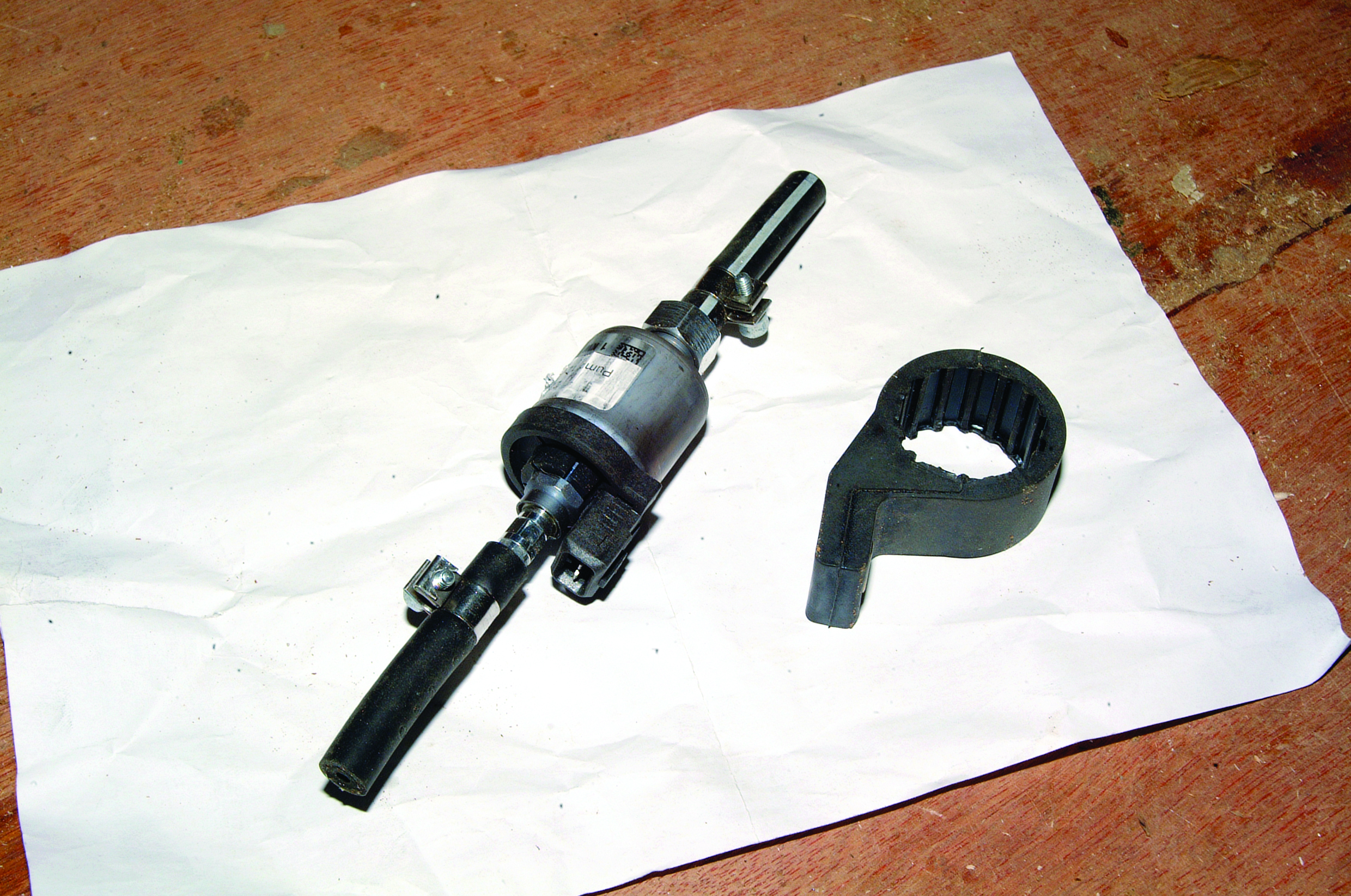 I can see two mechanical parts laid out on a white cloth on a wooden surface, but this does not appear to be a boating image - these look like automotive or machinery components rather than marine equipment // Photo credit: supplied.