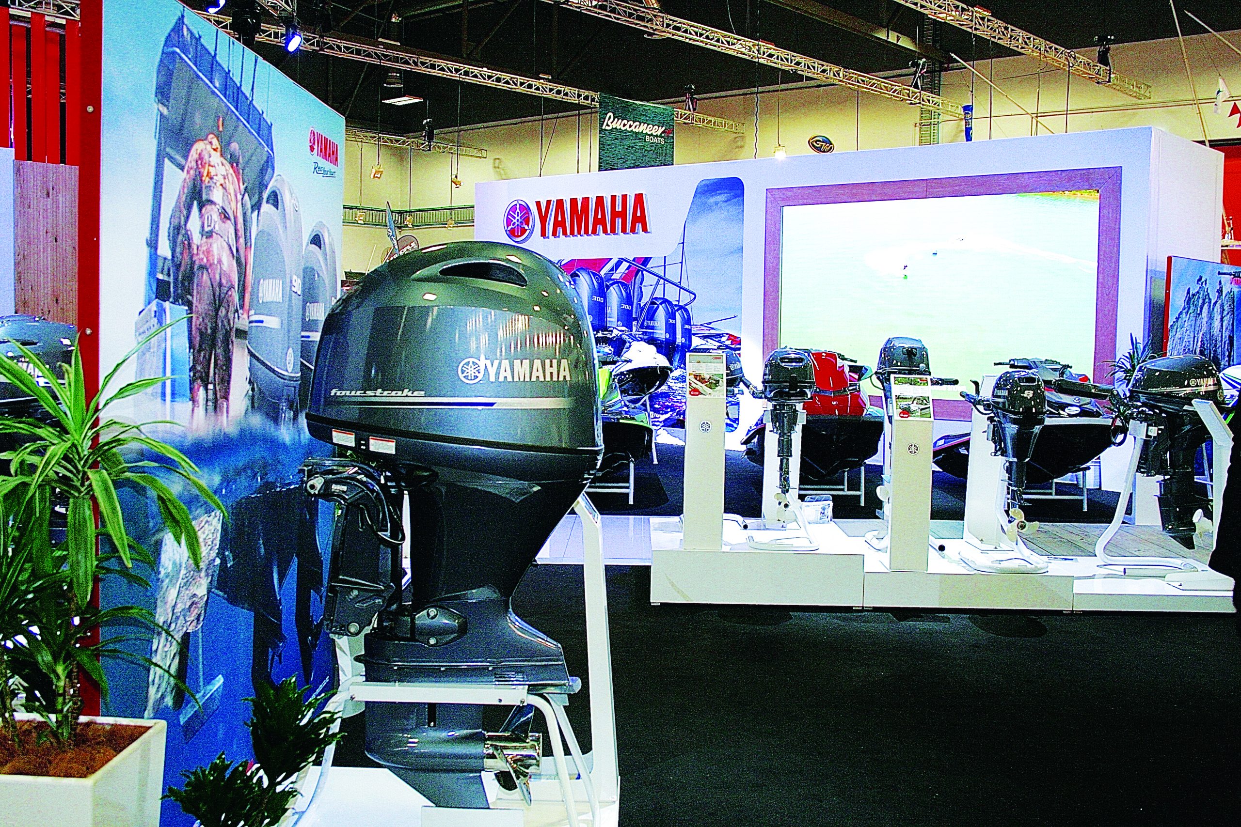 Yamaha outboard motors are displayed at a marine trade show booth featuring various engine models on white display stands // Photo credit: supplied.