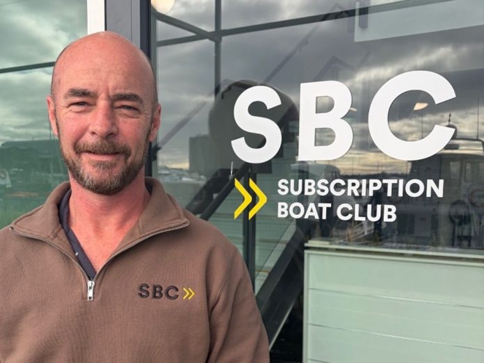 Colin Stone in front of the rebranded Subscription Boat Club front door. // Supplied