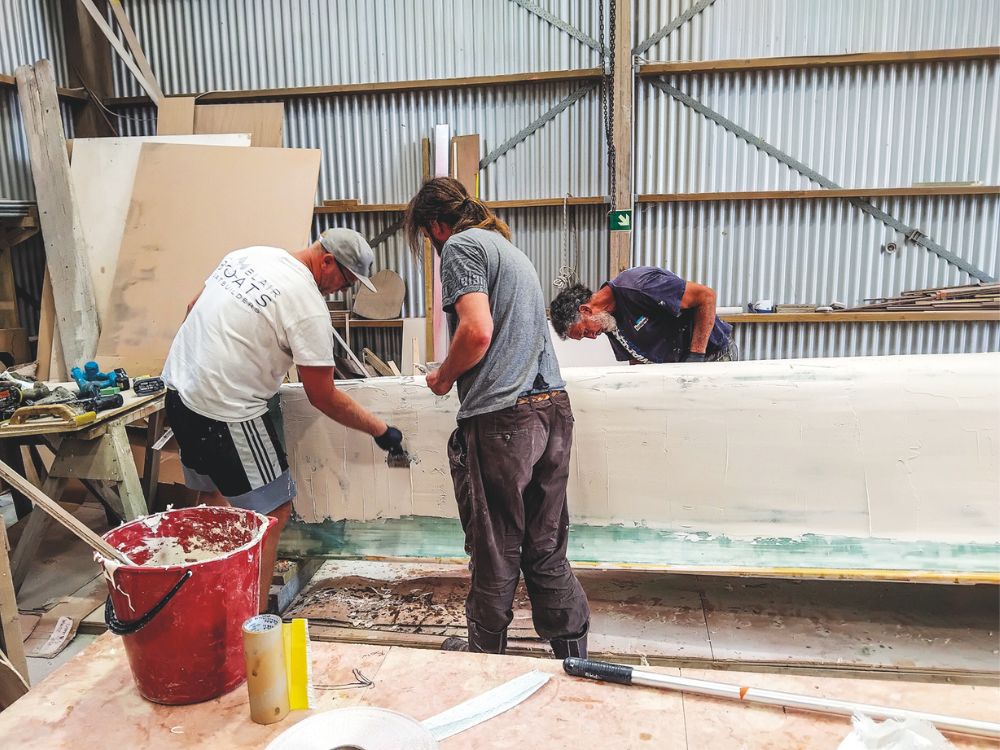 Fairing the bow at Blair Boats, Laurie on the left.