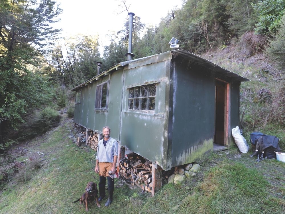 Grant Allott outside Walkers Hut. // Photo credit: Tom Fraser