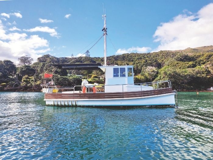 A launch moored in the harbour, Great Barrier Island. // Photo credit: Alex Stone