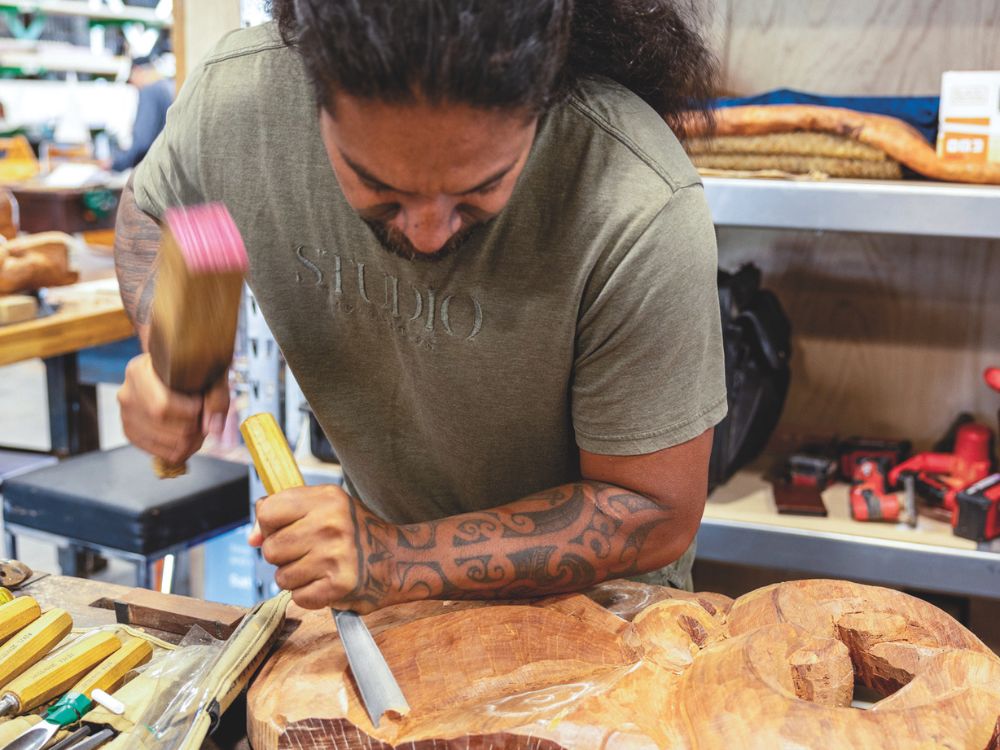 A carver at work at the 2026 Auckland Wooden Boat Festival. // Photo credit: Roger Mills