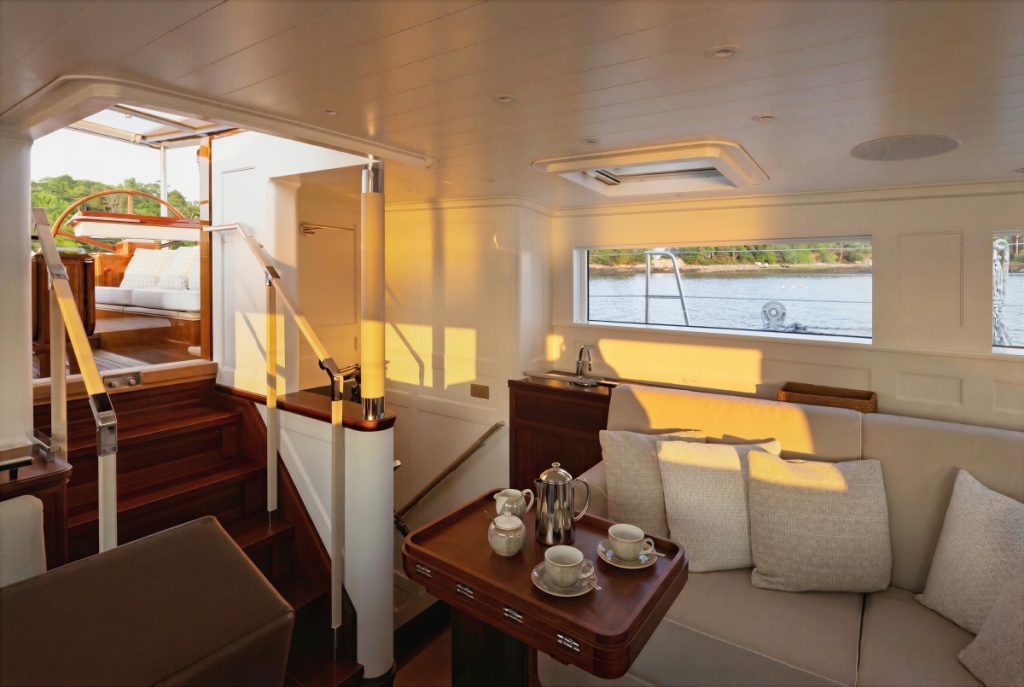 PROJECT OUZEL | APPROVED PHOTOGRAPHY ©Russell_Kaye_Ouzel__Ouzel_Russell_Kaye_R5_33289- MWD2-2-HR-Approved.jpg A sunlit seating nook aboard Ouzel opens directly to the companionway and cockpit above. // Photo credit: Russell Kaye