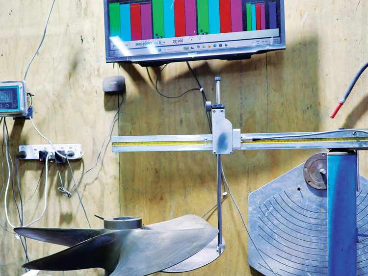 A propeller being measured in the Prop Scan system, right, and newly-cast propellers awaiting finishing.