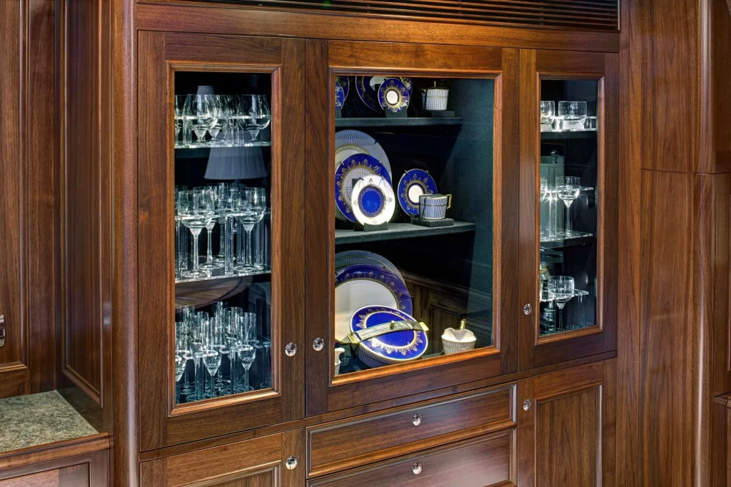 A dedicated display cabinet houses Villeroy & Boch crystal and Wedgwood china, reflecting Encore’s traditional interior - Encore superyacht // Photo courtesy McD Yachts
