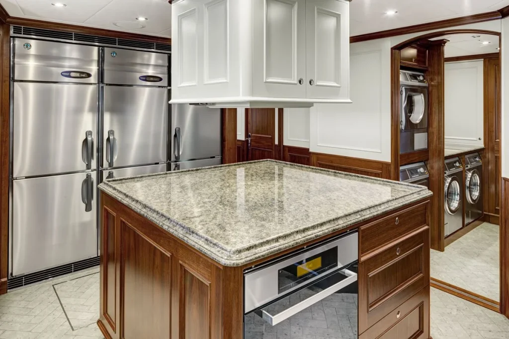 The spacious galley combines substantial refrigeration, an island worktop and Miele appliances for extended cruising // Photo courtesy McD Yachts