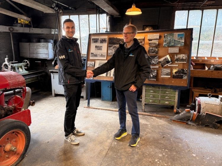 Mike Hamilton congratulates Sam Hamilton as his successor as Chairman in the original workshop where the jets were designed, on site at Irishman Creek Station in the Mackenzie Basin. // Photo courtesy HamiltonJet