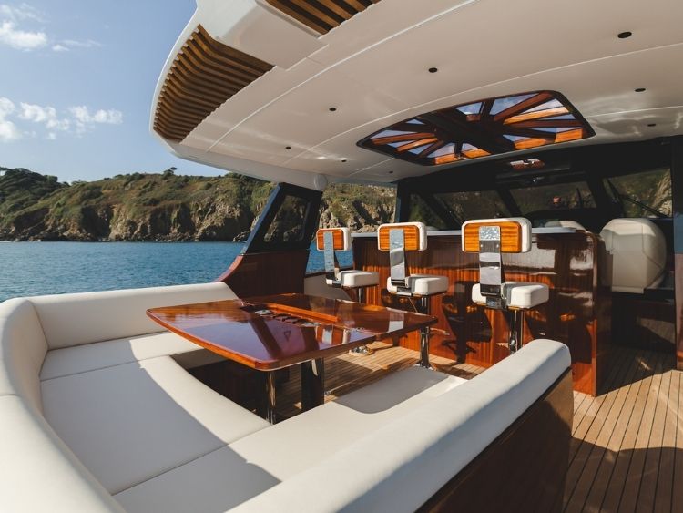 A handcrafted mahogany table, generous cockpit seating and three bar stools put entertaining at the centre of the P50’s layout. // Photo courtesy Spirit Yachts